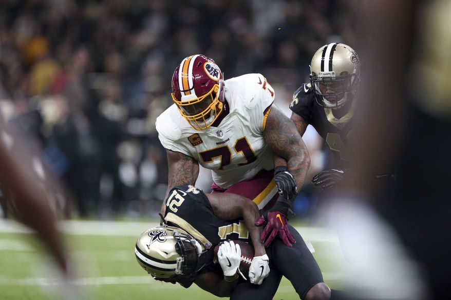 New Orleans Saints cornerback De'Vante Harris (21) tries but fails to hold onto a near interception as Washington Redskins offensive tackle Trent Williams (71) brings him down in the first half of an NFL football game in New Orleans, Sunday, Nov. 19, 2017. (AP Photo/Rusty Costanza) **FILE**