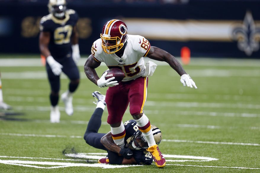 Washington Redskins tight end Vernon Davis (85) carries as New Orleans Saints free safety Vonn Bell (48) tries to tackle in the first half of an NFL football game in New Orleans, Sunday, Nov. 19, 2017. (AP Photo/Butch Dill)
