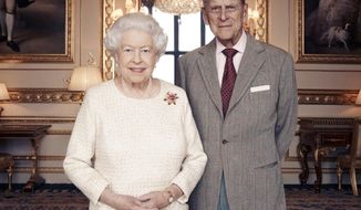 In this handout photo issued by Camera Press and taken in Nov. 2017, Britain&#39;s Queen Elizabeth and Prince Philip pose for a photograph in the White Drawing Room at Windsor Castle, England. Britain’s Queen Elizabeth II and Prince Philip are marking 70 years since they wed in London’s Westminster Abbey. At the time, Princess Elizabeth was just 21 and Philip, a naval officer, was 26. Their wedding was a spark of joy and celebration in a country just recovering from World War II. (Matt Holyoak/Camera Press via AP)