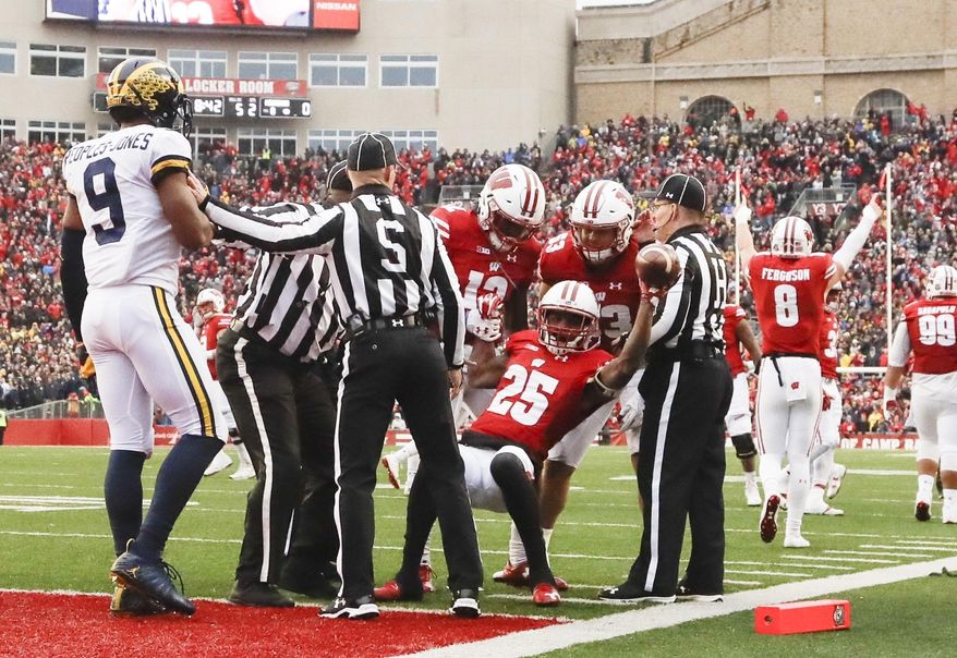 Wisconsin's Derrick Tindal is congratulated after recovering a fumble near the goal line during the first half of an NCAA college football game against the MichiganSaturday, Nov. 18, 2017, in Madison, Wis. (AP Photo/Morry Gash)