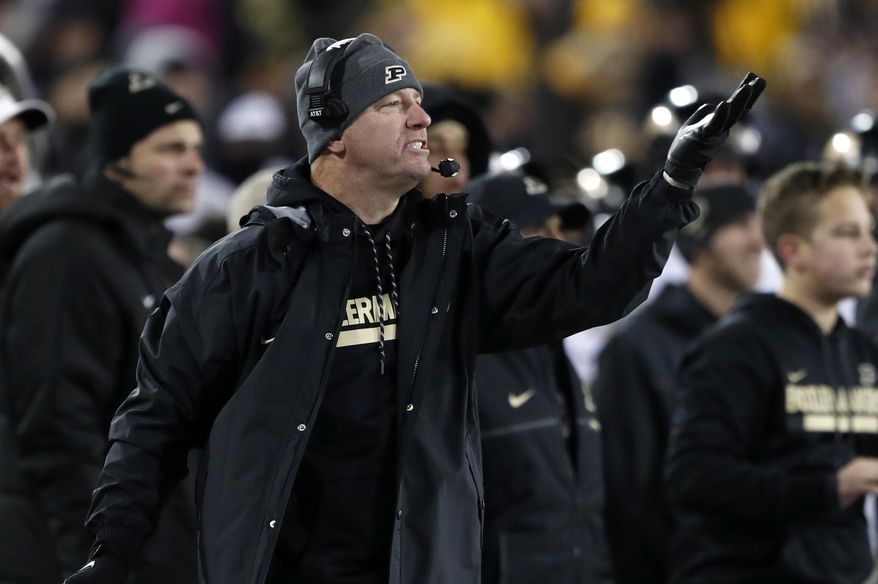 Purdue head coach Jeff Brohm directs his team during the second half of an NCAA college football game against Iowa, Saturday, Nov. 18, 2017, in Iowa City, Iowa. Purdue won 24-15. (AP Photo/Charlie Neibergall)