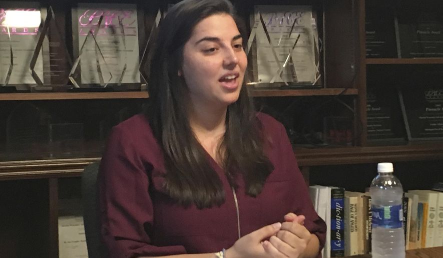 In this Nov. 2, 2017 photo Katie Fahey, president and treasurer of the ballot committee Voters Not Politicians, speaks to reporters at the Martin Waymire public relations firm in Lansing, Mich. The group has surprised by using an all-volunteer legion of petition circulators to gather at least 350,000 signatures for a 2018 ballot drive against partisan gerrymandering. (AP Photo/David Eggert)