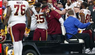 Washington Redskins running back Chris Thompson (25) is helped onto a cart after being injured in the second half of an NFL football game against the New Orleans Saints in New Orleans, Sunday, Nov. 19, 2017. (AP Photo/Butch Dill)