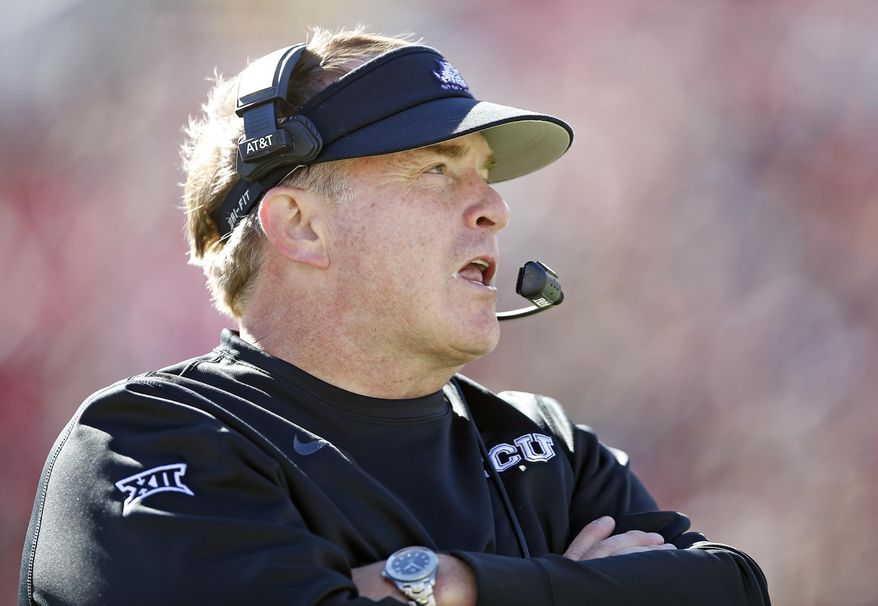 TCU coach Gary Patterson talks to his assistant coaches during the second half of the NCAA college football game against Texas Tech, Saturday, Nov. 18, 2017, in Lubbock, Texas. (AP Photo/Brad Tollefson)
