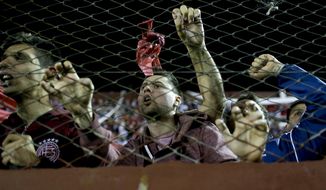 In this Oct. 31, 2017 photo, Argentina&#39;s Lanus fans cheer for their team during a semifinals Copa Libertadores soccer match against Argentina&#39;s River Plate in Buenos Aires, Argentina. Lanus, a small soccer club from Buenos Aires suburbs, qualified for the first time in its history to the final of the Copa Libertadores, and will face Brazil&#39;s Gremio in the Copa Libertadores final on Nov. 22 and 29. (AP Photo/Natacha Pisarenko)