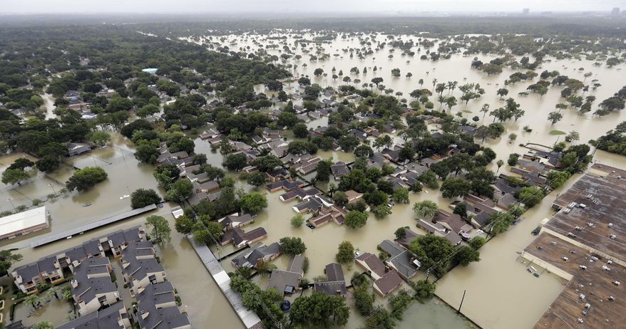 FILE - In this Tuesday, Aug. 29, 2017 file photo, a neighborhood near Houston's Addicks Reservoir is flooded after heavy rains from Tropical Storm Harvey. A study released Monday, Nov. 20, 2017 predicts that summer thunderstorms in North America will likely be larger, wetter and more frequent in a warmer world, dumping 80 percent more rain in some areas and worsening flooding. (AP Photo/David J. Phillip)