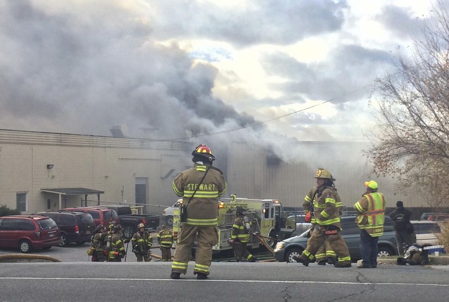 Firefighters work at the scene of of a fire Monday, Nov. 20, 2017, at the Verla International cosmetics factory on Temple Hill Road in New Windsor, NY. Authorities say two explosions and a fire at the cosmetics factory in the Hudson Valley have left numerous people injured, including firefighters caught in the second blast. (Allyse Pulliam/Times Herald-Record via AP)
