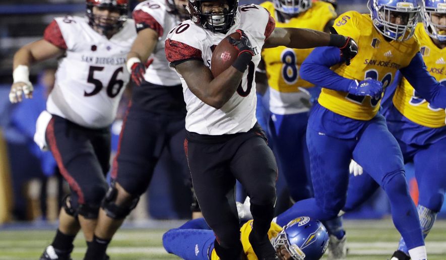 FILE - In a Saturday, Nov. 4, 2017 file photo, San Diego State running back Rashaad Penny runs against San Jose State during an NCAA college football game against San Jose State, in San Jose, Calif. Penny set a national season high with his 429 all-purpose yards against Nevada. He also became the first player since 1996 with two rushing touchdowns, one kick return touchdown and one punt return touchdown in the same game.(AP Photo/Marcio Jose Sanchez, File)