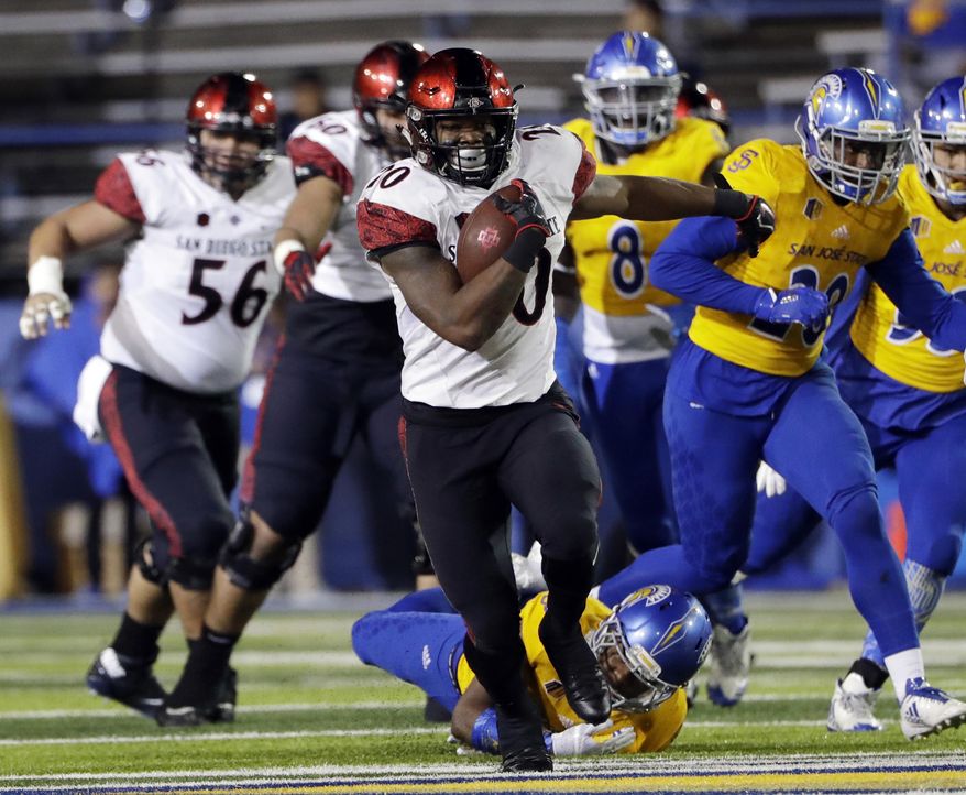 FILE - In a Saturday, Nov. 4, 2017 file photo, San Diego State running back Rashaad Penny runs against San Jose State during an NCAA college football game against San Jose State, in San Jose, Calif. Penny set a national season high with his 429 all-purpose yards against Nevada. He also became the first player since 1996 with two rushing touchdowns, one kick return touchdown and one punt return touchdown in the same game.(AP Photo/Marcio Jose Sanchez, File)