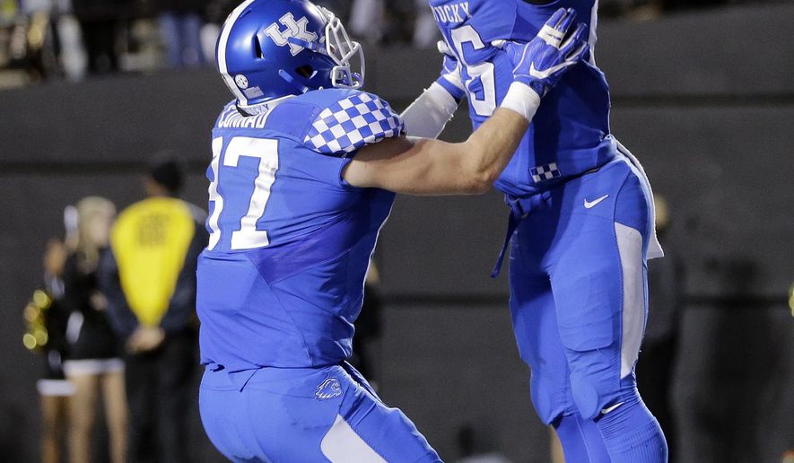 Kentucky running back Benny Snell Jr. (26) celebrates with tight end C. J. Conrad (87) after scoring a touchdown on a 6-yard run against Vanderbilt in the second half of an NCAA college football game Saturday, Nov. 11, 2017, in Nashville, Tenn. (AP Photo/Mark Humphrey)
