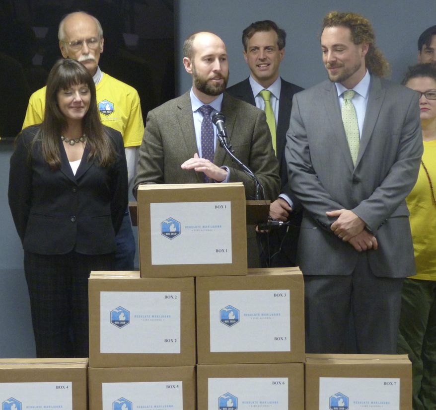 Josh Hovey, spokesman for the Coalition to Regulate Marijuana Like Alcohol, speaks at a news conference on Monday, Nov. 20, 2017, at an office building in Lansing, Mich. The group submitted more than 360,000 signatures for a 2018 ballot drive to legalize the use of marijuana for recreational purposes. (AP Photo/David Eggert)