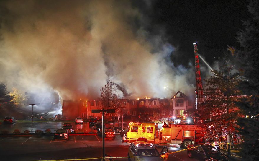 In this Thursday, Nov. 16, 2017 photo, fire fighters battle a blaze at the Barclay Friends Senior Living Community in West Chester, Pa. At least 20 people were injured in the massive fire at the senior living community about 35 miles west of Philadelphia. (Steven M. Falk/The Philadelphia Inquirer via AP)
