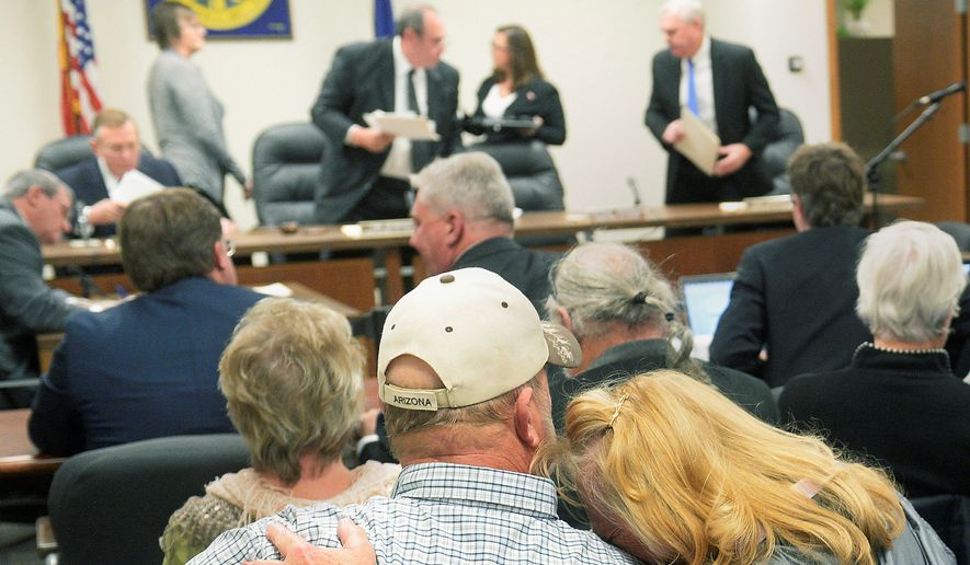 Diana Steskal rests her head on her husband Byron&#x27;s shoulder as Nebraska Public Service Commissioners rise to leave following their vote approving the TransCanada&#x27;s Keystone XL pipeline &quot;mainline alternative route&quot; through the state Monday, Nov. 20, 2017, in Lincoln, Neb. The couple are landowners in the path of the pipeline. (Eric Gregory/The Journal-Star via AP) ** FILE **