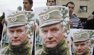 A May 29, 2011 file photo shows Bosnian Serb protesters holding posters depicting former Bosnian Serb army chief Ratko Mladic, during a protest in Mladic&#39;s hometown of Kalinovik, Bosnia-Herzegovina. (AP Photo/Amel Emric, File)