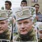 A May 29, 2011 file photo shows Bosnian Serb protesters holding posters depicting former Bosnian Serb army chief Ratko Mladic, during a protest in Mladic&#39;s hometown of Kalinovik, Bosnia-Herzegovina. (AP Photo/Amel Emric, File)