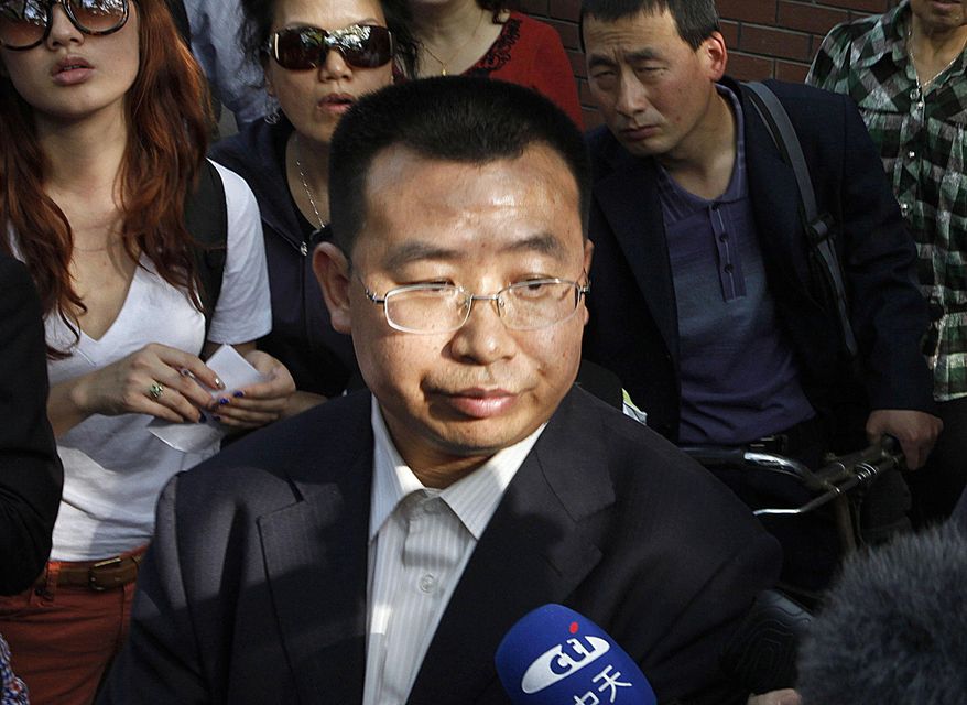 FILE - In this May 2, 2012, file photo, human rights activist Jiang Tianyong speaks to journalists outside a hospital after his failed attempt to see blind Chinese activist Chen Guangcheng who is believed to be seeking treatment in Beijing, China. A court in central China has sentenced Jiang to two years in prison Tuesday, Nov. 21, 2017, on the vague charge of inciting subversion of state power, the latest verdict to be handed down in a sweeping crackdown on activism. (AP Photo/Ng Han Guan, File)
