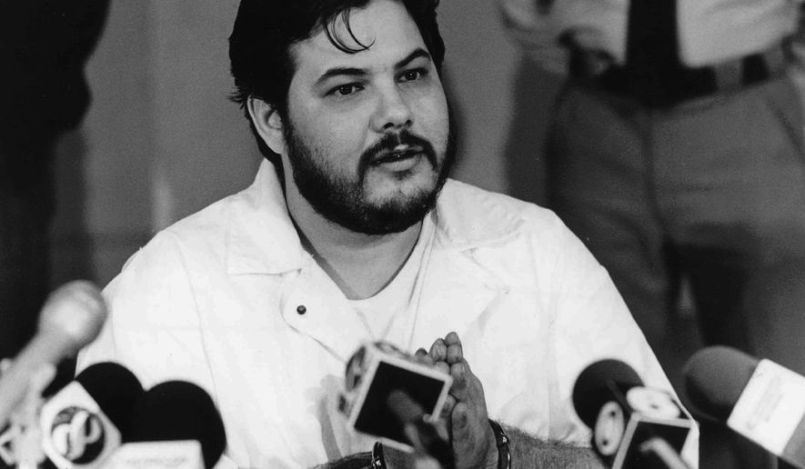FILE - In this 1991 file photo, Joseph M. Giarratano, who was stabbed on July 4, 1996, at Buckingham Correctional Center, speaks with members of the media in Buckingham, Va. Giarratano, who had his sentence commuted to life in prison more than two decades ago, has been granted parole. The Richmond Times-Dispatch reports the Virginia State Parole Board on Monday, Nov. 20, 2017, approved Giarratano for release. (Lindy Keast Rodman/Richmond Times-Dispatch via AP, File)