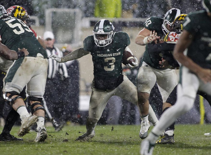 Michigan State's LJ Scott (3) rushes against Maryland during the second half of an NCAA college football game, Saturday, Nov. 18, 2017, in East Lansing, Mich. Michigan State won 17-7. (AP Photo/Al Goldis)