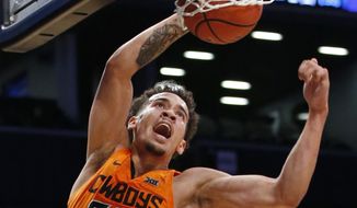 Oklahoma State guard Jeffrey Carroll (30) dunks during the second half of an NCAA college basketball game against Pittsburgh in the Legends Classic tournament, Tuesday, Nov. 21, 2017, in New York. Carroll had 29 points as Oklahoma State defeated Pittsburgh 73-67. (AP Photo/Kathy Willens)