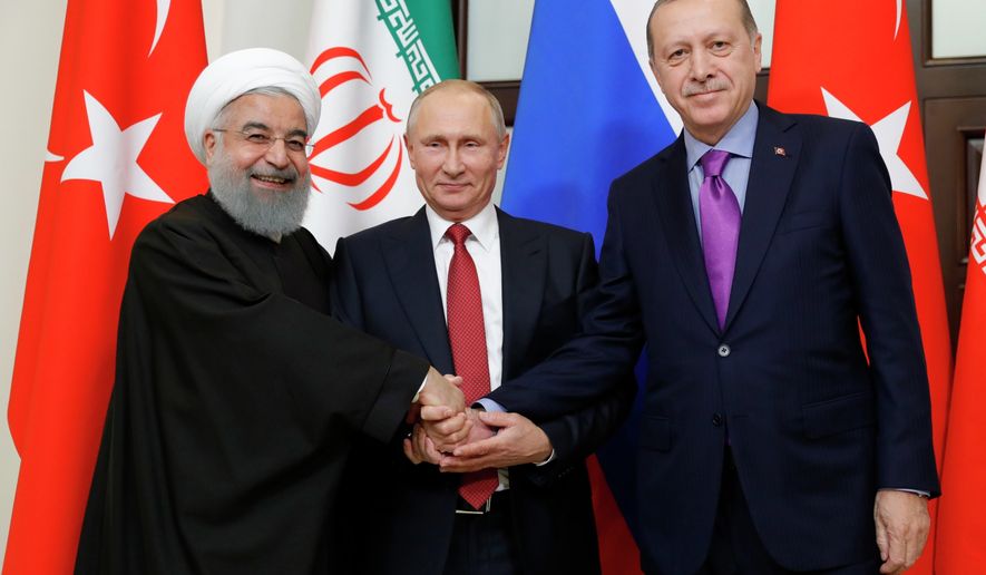 From left, President of Iran Hassan Rouhani, Russian President Vladimir Putin and Turkish President Recep Tayyip Erdogan shake hands at the start of the talks in Russia&#x27;s Black Sea resort of Sochi, on Wednesday, Nov. 22, 2017. The presidents of Turkey and Iran have hailed their trilateral talks with Russia on Syria&#x27;s future as critical for restoring peace in the war-torn nation. (Mikhail Klimentyev, Kremlin Pool Photo via AP)