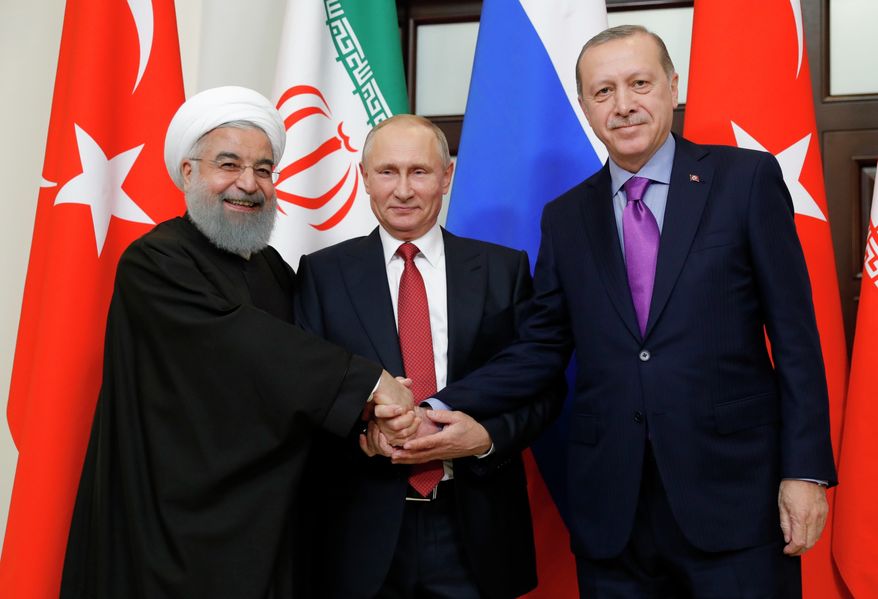 From left, President of Iran Hassan Rouhani, Russian President Vladimir Putin and Turkish President Recep Tayyip Erdogan shake hands at the start of the talks in Russia&#x27;s Black Sea resort of Sochi, on Wednesday, Nov. 22, 2017. The presidents of Turkey and Iran have hailed their trilateral talks with Russia on Syria&#x27;s future as critical for restoring peace in the war-torn nation. (Mikhail Klimentyev, Kremlin Pool Photo via AP)