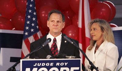 FILE - In this Tuesday, June 6, 2006 file photo, Judge Roy Moore stands with his wife, Kayla, after conceding the governor&#39;s race to Gov. Bob Riley, in Gadsden, Ala. (AP Photo/Butch Dill)