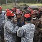 In this Saturday, Nov. 18, 2017 photo, soldiers from the U.S. Army and China&#39;s People&#39;s Liberation Army carry out a joint rescue response to a natural disaster in an exercise at Camp Rilea Armed Forces Training Center near Warrenton, Ore. It was only a drill, but roughly 100 soldiers from China and the U.S. and their top commanders are ready to use what they learned in a real disaster. The commander of U.S. Army-Pacific said Sunday - the last day of the exercise - that carrying out joint disaster responses shouldn’t depend on the state of relations between the two world powers. Gen. Robert Brown says the participants found a common interest in saving lives. (AP Photo/Andrew Selsky)