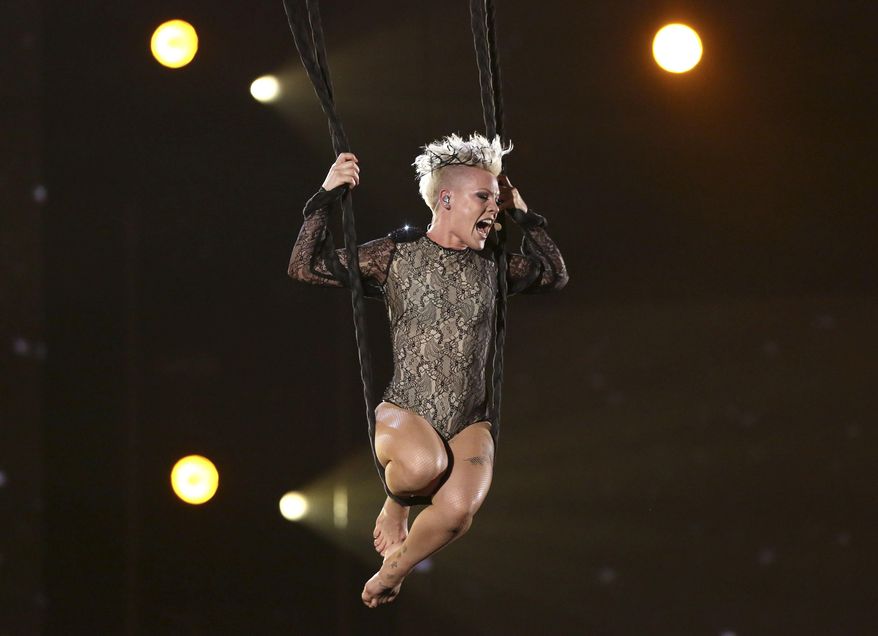 FILE - In this Jan. 26, 2014 file photo, Pink performs "Just Give Me a Reason" at the 56th annual Grammy Awards in Los Angeles. Pink's performance will be highlighted in “Grammys’ Greatest Stories: A 60th Anniversary Special” airing Friday on CBS. (Photo by Matt Sayles/Invision/AP, File)