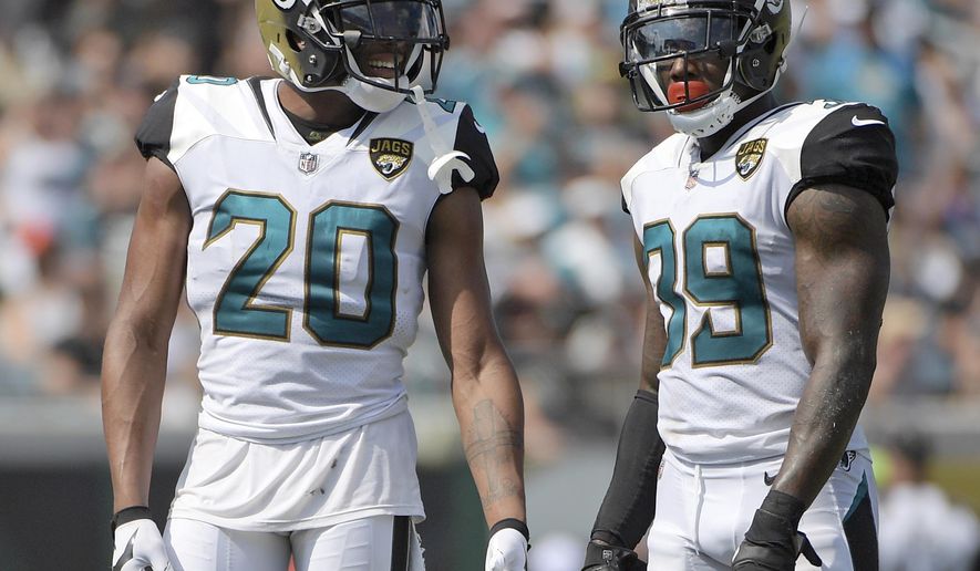 FILE - In this Sept. 17, 2017, file photo, Jacksonville Jaguars cornerback Jalen Ramsey (20) and free safety Tashaun Gipson (39) wait for a play during the second half an NFL football game against the Tennessee Titans in Jacksonville, Fla. Gipson and his fellow defensive backs have started a "DB fund" that grows every time one of them drops an interception. The secondary plans to use the money for a group trip after the season. (AP Photo/Phelan M. Ebenhack, File)