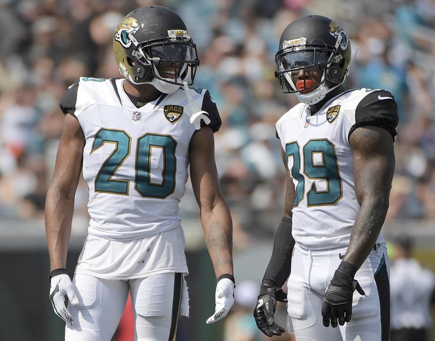 FILE - In this Sept. 17, 2017, file photo, Jacksonville Jaguars cornerback Jalen Ramsey (20) and free safety Tashaun Gipson (39) wait for a play during the second half an NFL football game against the Tennessee Titans in Jacksonville, Fla. Gipson and his fellow defensive backs have started a "DB fund" that grows every time one of them drops an interception. The secondary plans to use the money for a group trip after the season. (AP Photo/Phelan M. Ebenhack, File)