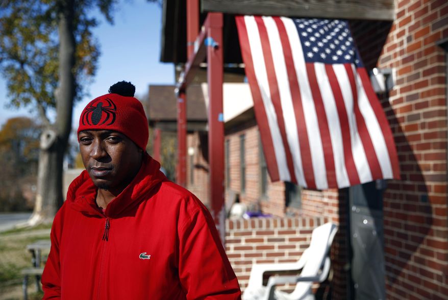 Sabein Burgess stands outside his mother's home in Baltimore, Wednesday, Nov. 22, 2017. A federal jury awarded $15 million to Burgess Tuesday in his lawsuit against the Baltimore Police Department and two detectives. Burgess, who spent nearly two decades in prison after being wrongfully convicted of killing his girlfriend, was released in 2015 after being exonerated. (AP Photo/Patrick Semansky)