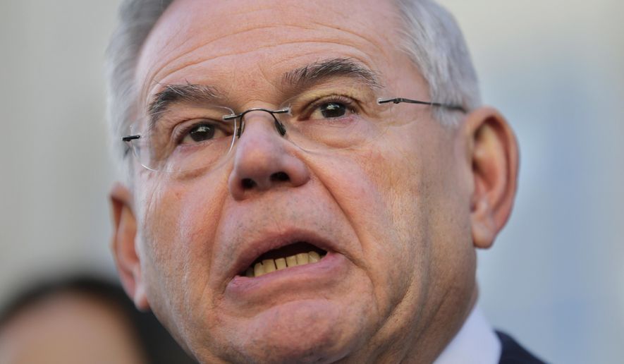 FILE - In this Nov. 16, 2017 file photo, Sen. Bob Menendez, D-N,J, speaks to reporters in front of the courthouse in Newark, N.J., after the jury in his federal bribery trial failed to reach a verdict. Defense attorney Jonathan Cogan says he doesn't expect the Department of Justice to spend a long time determining whether to retry Menendez and his longtime friend Salomon Melgen. (AP Photo/Seth Wenig)
