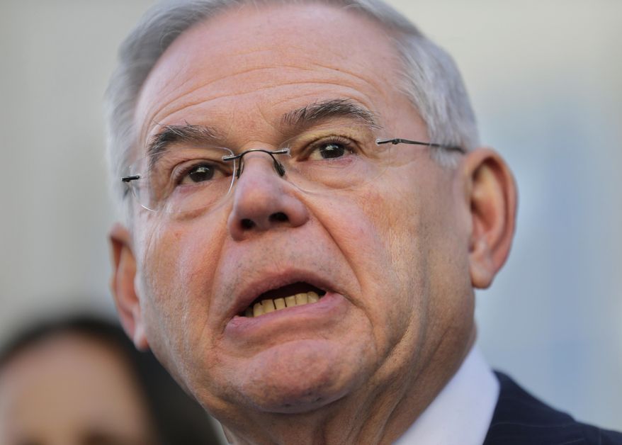 FILE - In this Nov. 16, 2017 file photo, Sen. Bob Menendez, D-N,J, speaks to reporters in front of the courthouse in Newark, N.J., after the jury in his federal bribery trial failed to reach a verdict. Defense attorney Jonathan Cogan says he doesn't expect the Department of Justice to spend a long time determining whether to retry Menendez and his longtime friend Salomon Melgen. (AP Photo/Seth Wenig)