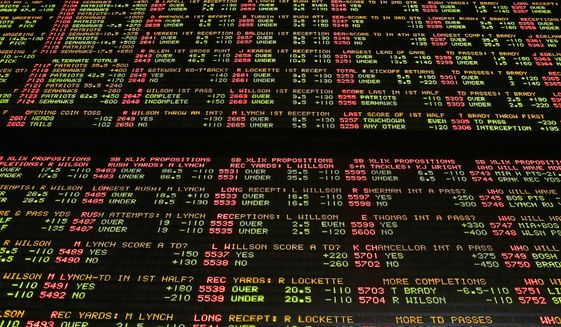 FILE – In this Jan. 27, 2015, file photo, Super Bowl proposition bets are displayed on a board at the Westgate Las Vegas SuperBook race and sports book in Las Vegas. The U.S. Supreme Court is set to hear arguments Dec. 4, 2017, as the state of New Jersey challenges a 1992 law forbidding state-authorized sports gambling in all but four states that met a 1991 deadline to legalize it: Delaware, Montana, Nevada and Oregon. (AP Photo/John Locher) ** FILE **