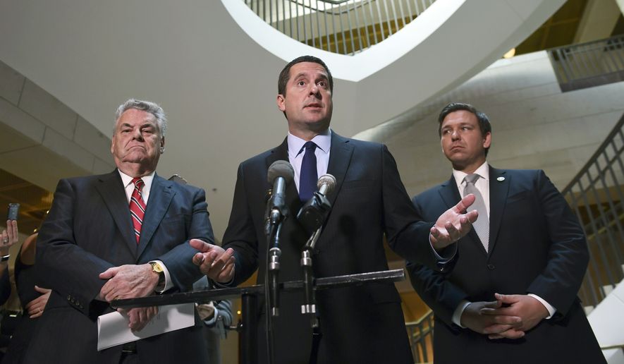 House Intelligence Committee Chairman Rep. Devin Nunes, R-Calif., center, standing with Rep. Peter King, R-N.Y., left, and Rep. Ron DeSantis, R-Fla., right, speaks on Capitol Hill in Washington. Mr. Nunes wants to know if the FBI knew the dossier was funded by the Democratic Party in the summer and fall of 2016, when the bureau opened a Trump-Russia counterintelligence probe. (AP Photo/Susan Walsh, File)