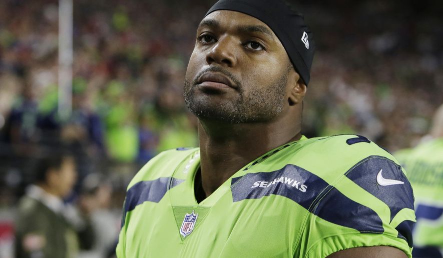 FILE - In this Nov. 9, 2017, file photo, Seattle Seahawks defensive end Dwight Freeney (93) watches play during an NFL football game against the Arizona Cardinals in Glendale, Ariz. The Detroit Lions have added Freeney off waivers from Seattle. Detroit acquired the 37-year-old Freeney Wednesday, Nov. 22, a day before hosting the Minnesota Vikings in a possibly pivotal game for the NFC North title. (AP Photo/Rick Scuteri, File)