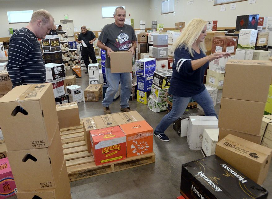 Employees at the Cottonwood Heights, Utah, state liquor store sort through a shipment of spirits on Wednesday, Nov. 22, 2017. (Al Hartmann/The Salt Lake Tribune via AP)