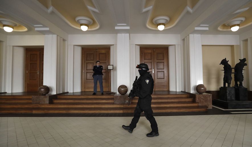 A prison guard walks outside a courtroom during an appeal by Yevgeniy Nikulin from Russia who faces charges of hacking computers of American companies, Friday, Nov. 24, 2017, in Prague, Czech Republic. Czech authorities arrested Nikulin in Prague in cooperation with the FBI in October last year. He is accused by U.S. prosecutors of penetrating computers at Silicon Valley firms including LinkedIn and Dropbox in 2012. (AP Photo/Petr David Josek)