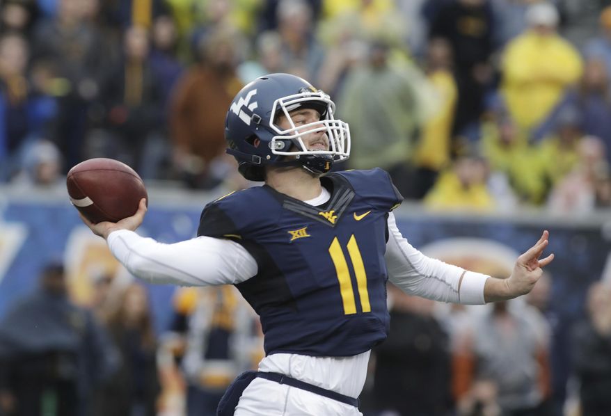 West Virginia quarterback Chris Chugunov (11) attempts a pass during the second half of an NCAA college football game against Texas, Saturday, Nov. 18, 2017, in Morgantown, W.Va. Texas defeated West Virginia 28-14. (AP Photo/Raymond Thompson)