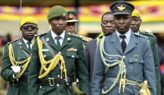 Emmerson Mnangagwa (center right) with army Gen. Constantino Chiwenga, inspected the military parade after being sworn in as Zimbabwe&#39;s president on Nov. 24. The military&#39;s stunning and prominent role in overthrowing Robert Mugabe and the way the bloodless coup was conducted have raised questions about whether the troops will return to their barracks so readily. (Associated Press/File)