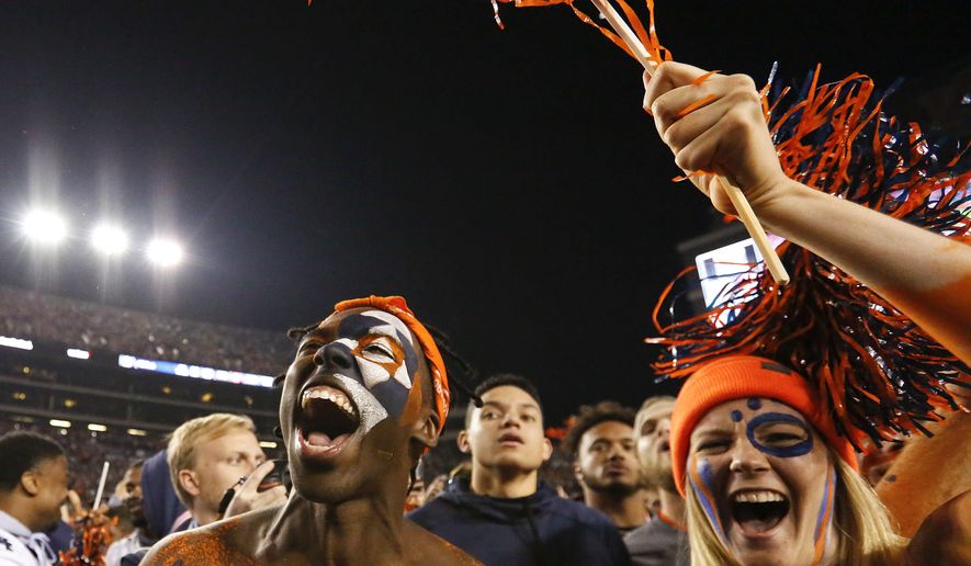 Fans cheer as they rush the field after Auburn defeated Alabama 26-14 in the Iron Bowl NCAA college football game, Saturday, Nov. 25, 2017, in Auburn, Ala. (AP Photo/Brynn Anderson)