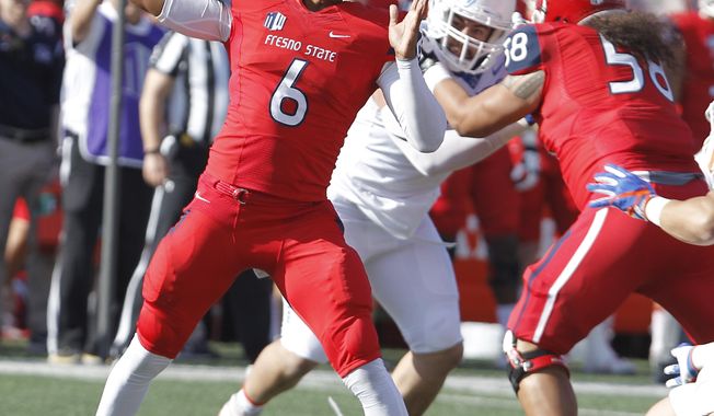 Fresno State's quarterback Marcus McMaryion drops back to pass against Boise State during the first half of an NCAA college football game in Fresno, Calif., Saturday, Nov. 25 2017. (AP Photo/Gary Kazanjian)