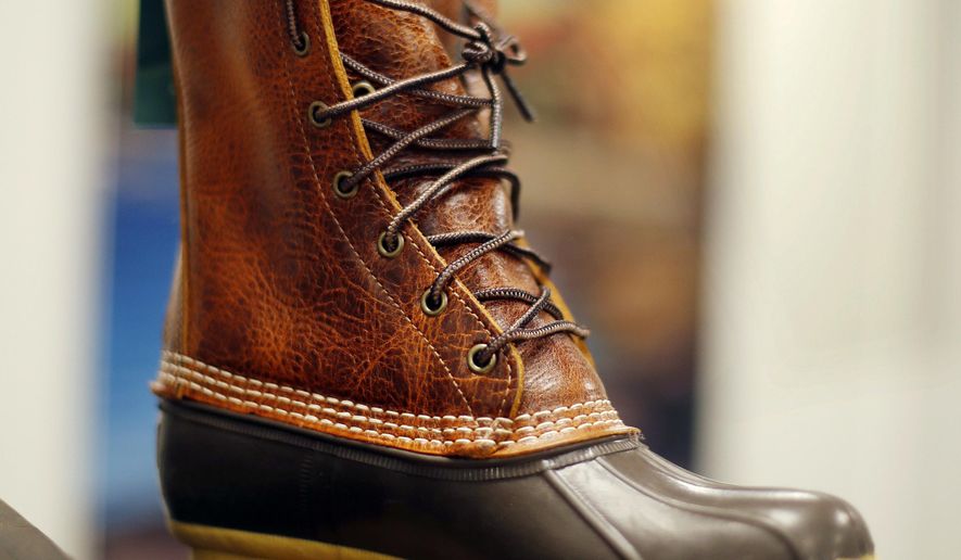 FILE - In this Aug. 17, 2017 file photo, a Bean Boot displayed at the L.L. Bean manufacturing center in Lewiston, Maine, Bean said it's in the midst of another record breaking year of sales for its iconic 'duck boot,' and there will be enough to meet the 2017 holiday crunch. (AP Photo/Robert F. Bukaty, File)