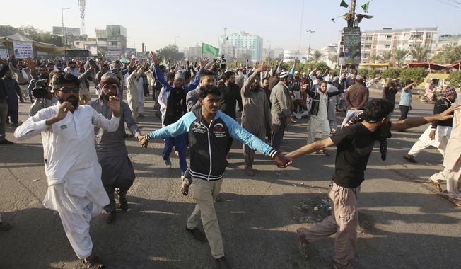 Supporters of religious groups rally to express solidarity with protesters block main highway in capital, Saturday, Nov. 25, 2017. Pakistani police have launched an operation to clear an intersection linking capital Islamabad with the garrison city of Rawalpindi where an Islamist group&#x27;s supporters have camped out for the last 20 days. (AP Photo/Fareed Khan)