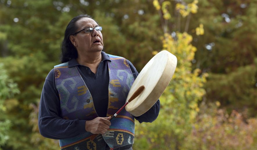 Dennis Zotigh poses for a photo outside the National Museum of the American Indian in Washington, Friday, Nov. 3, 2017. Many tribes even have their own national anthems known as flag songs that focus on veterans. They’re popular among Plains tribes from which the modern powwow originated, said Zotigh of the Smithsonian National Museum of the American Indian. Powwows are social gatherings, generally with competitive dancing. (AP Photo/Susan Walsh)