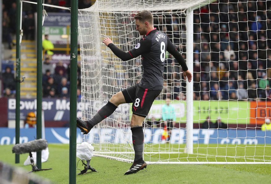 Arsenal's Aaron Ramsey kicks the goalpost in frustration after missing a chance to score, during the English Premier League soccer match between Burnley and Arsenal, at Turf Moor, in Burnley, England, Sunday Nov. 26, 2017. (Martin Rickett/PA via AP)