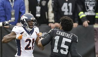 Denver Broncos cornerback Aqib Talib (21) fights Oakland Raiders wide receiver Michael Crabtree (15) during the first half of an NFL football game in Oakland, Calif., Sunday, Nov. 26, 2017. (AP Photo/Ben Margot) **FILE**
