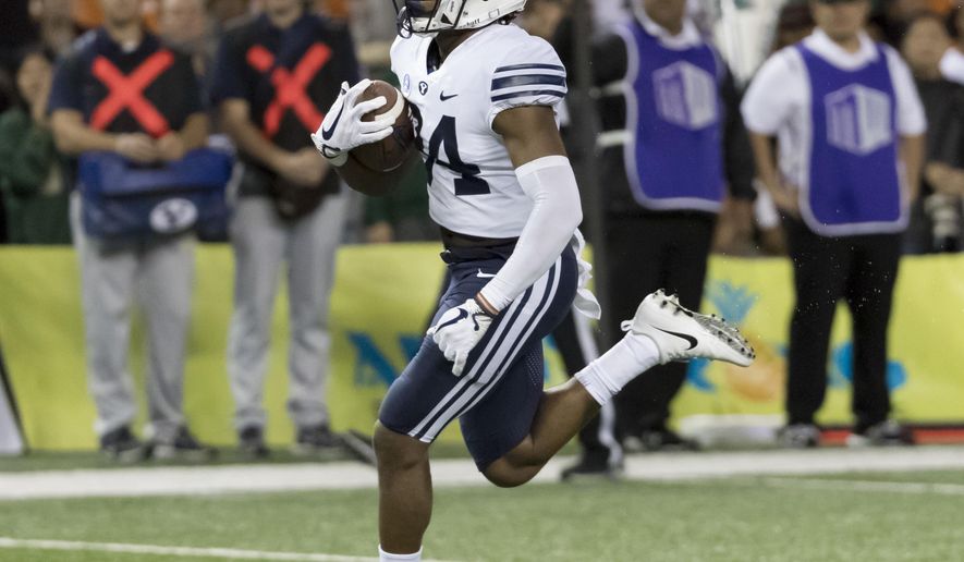 BYU running back Riley Burt scores a touchdown late in the fourth quarter of an NCAA college football game against Hawaii on Saturday, Nov. 25, 2017, in Honolulu. BYU won 30-20. (AP Photo/Eugene Tanner)