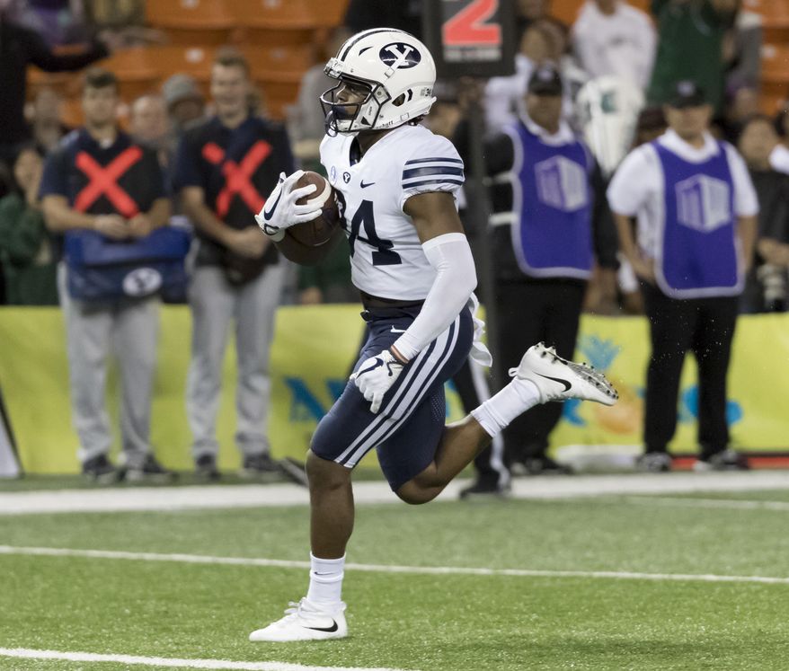 BYU running back Riley Burt scores a touchdown late in the fourth quarter of an NCAA college football game against Hawaii on Saturday, Nov. 25, 2017, in Honolulu. BYU won 30-20. (AP Photo/Eugene Tanner)
