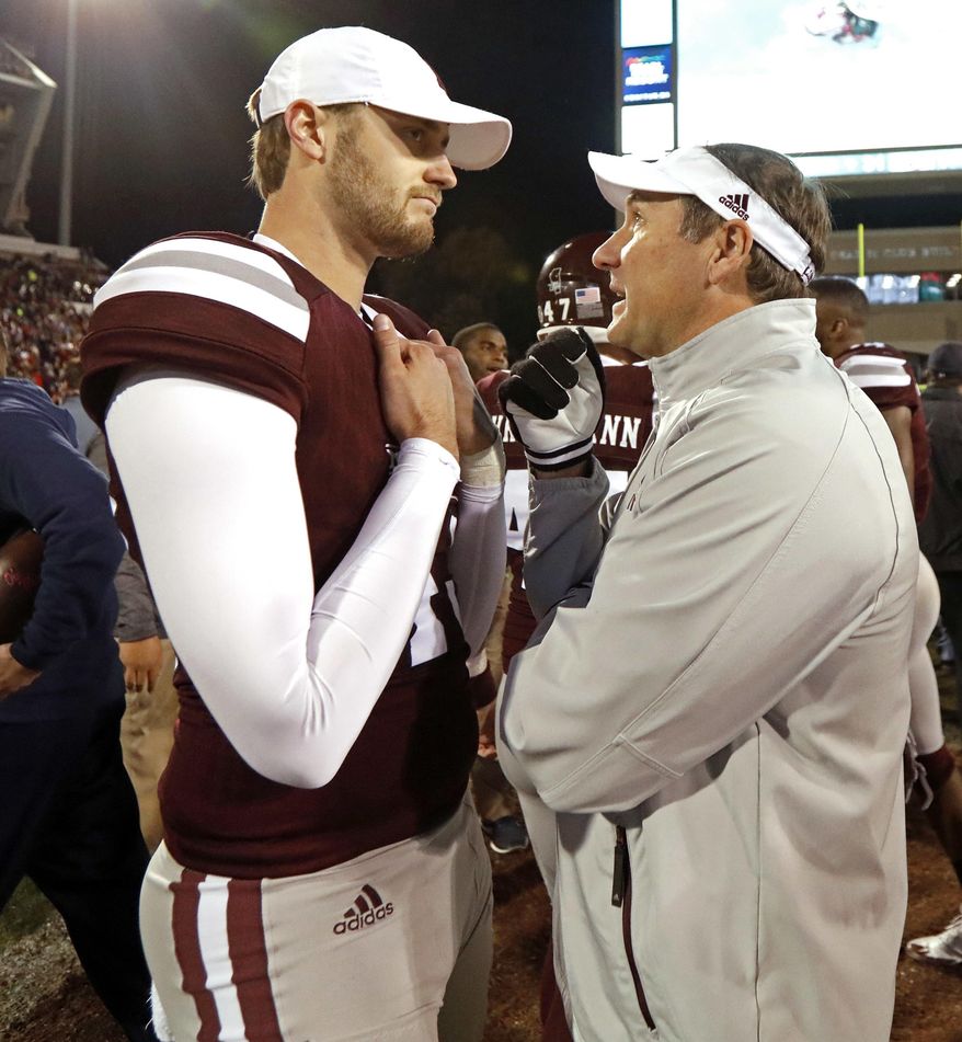 Mississippi State coach Dan Mullen speaks with punter Logan Cooke following the team's 31-28 loss to Mississippi in an NCAA college football game in Starkville, Miss., Thursday, Nov. 23, 2017. (AP Photo/Rogelio V. Solis)